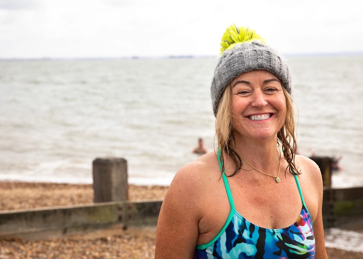 A smiling Own The Adventure swimmer after a sea dip